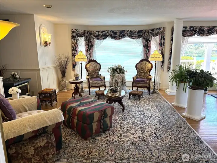Great room with a lake view. Note pellet stove to the left in the photo. Owner has lots of pellet supplies in the large shop/garage.