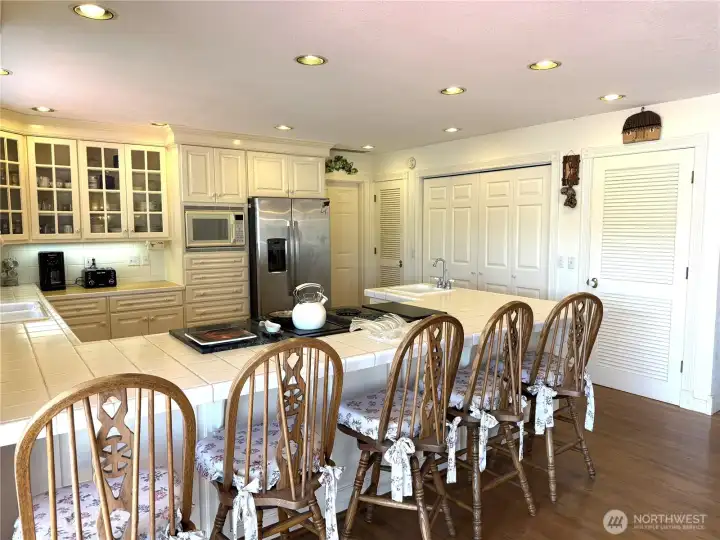 Bank of closets in the kitchen, far right door leads to a walk-in pantry.  Center double doors is the laundry closet.