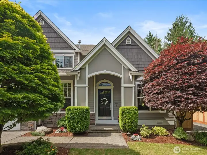 Front entry with architectural lines, manicured gardens, and a welcoming covered porch that sets the tone for the home's refined interiors.