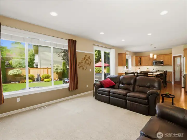 Enjoy year-round views of the private backyard from this spacious family room, which features a gas fireplace, custom bookshelves with lighting and storage.