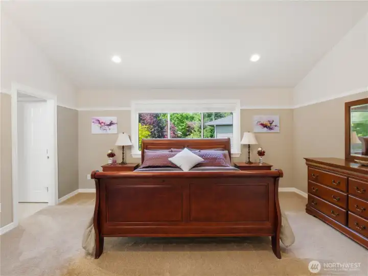 Bright and inviting primary suite designed for comfort and relaxation with large windows and a spacious layout.