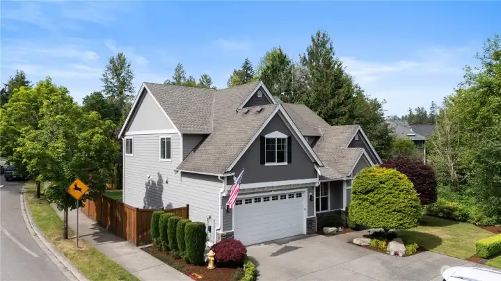 Set on a lush, landscaped lot surrounded by evergreens, this home offers exceptional curb appeal, privacy, and a welcoming presence.