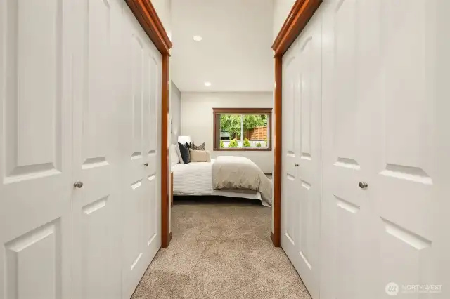 Primary double closets between bedroom and attached bathroom.