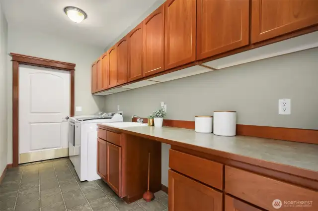 Massive laundry room with utility sink and storage.