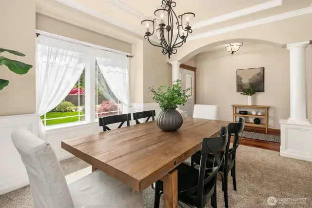 Notice column details and loads of light in the formal dining room.
