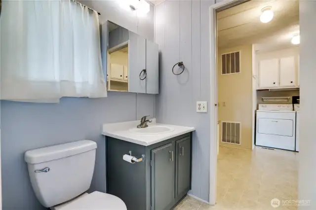 The second bathroom offers a vanity, large medicine cabinet and access to the laundry/office space.