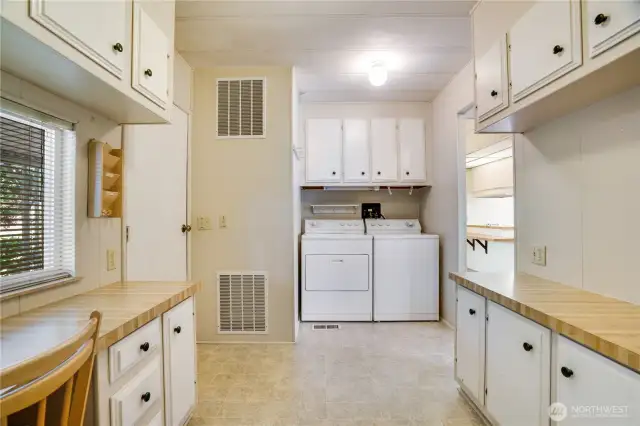 The office/laundry room provides additional storage and a pleasant place to sit and work.
