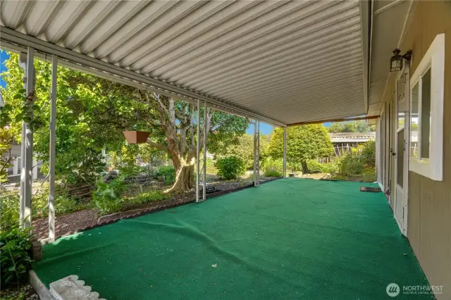 The second covered patio is spacious and provides a cool space to relax on summer days. The lush landscaping provides pleasant views.