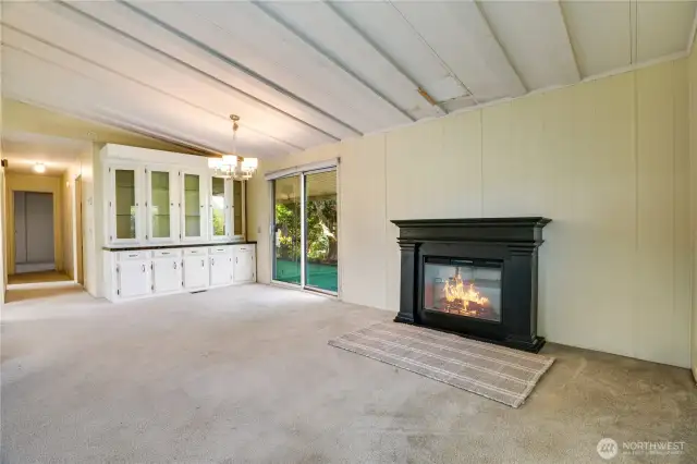 A previous free-standing stove was removed, and the electric fireplace was added. The sliding glass door in the dining room goes out to the second covered patio.