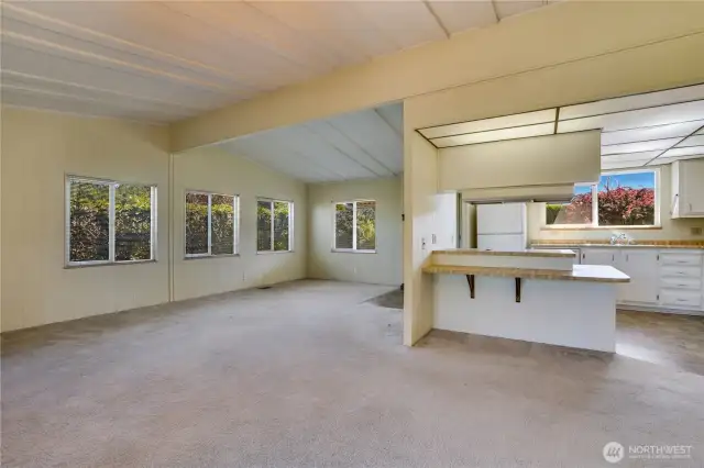 The open floor plan makes for easy entertaining. The vaulted ceilings provide a light and airy feel to the space.