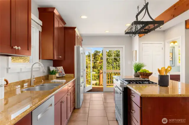 Kitchen opens directly to expansive, freshly-refinished deck