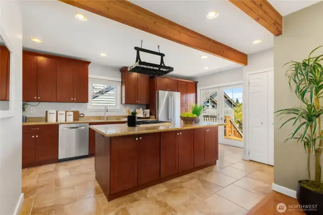 Enormous kitchen with granite tile counters, custom cherry cabinets, and matching stainless appliances
