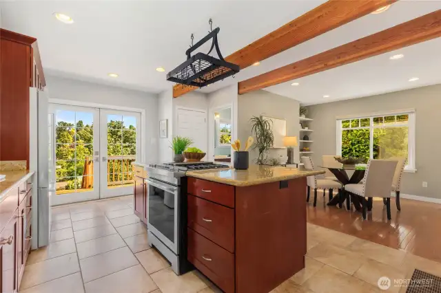 Enormous kitchen with granite tile counters, custom cherry cabinets, and matching stainless appliances