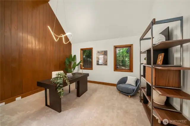 A dedicated home office offers a quiet, inspiring workspace, beautifully enhanced by rich wood-framed walls