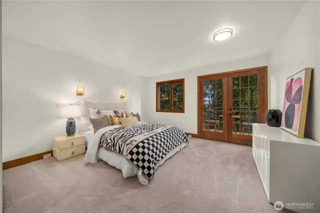 A bedroom suite on upper level with a private deck