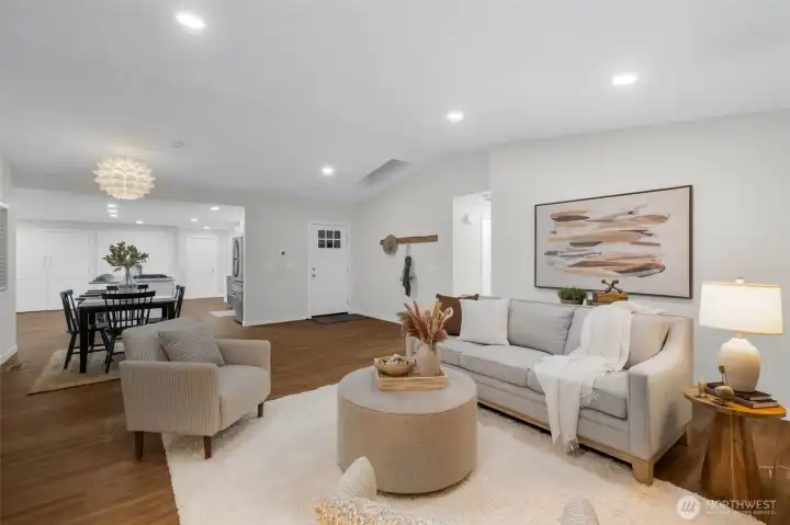 Living room flows into dining and kitchen spaces flawlessly.