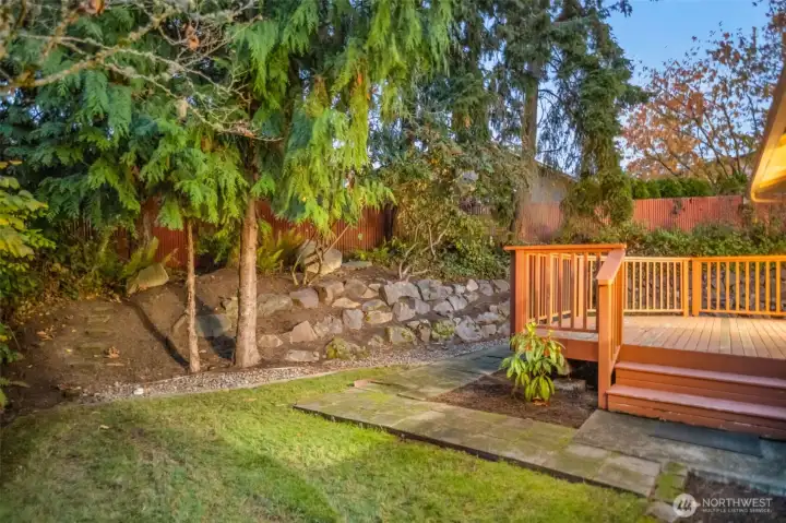 Deck off the living room surrounded by trees.
