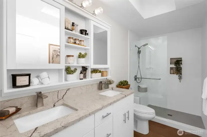 Large walking shower and double sinks are featured in the primary bath.