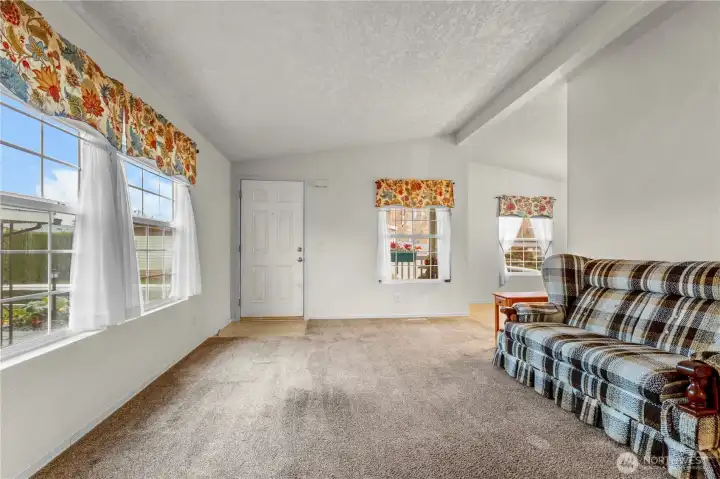 A view of the living room looking back toward the front door.