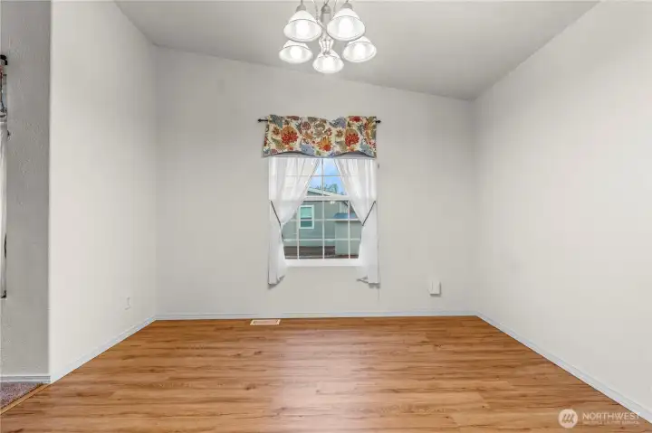 A view of the inviting dining room from the kitchen. This room offers plenty of space for gatherings and everyday meals.