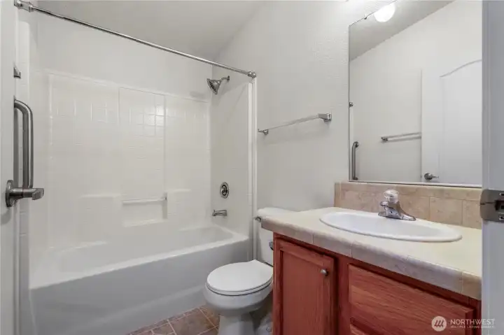 Hall/guest bathroom with shower/tub. In addition, there is a linen closet is in the hallway just outside the bathroom.