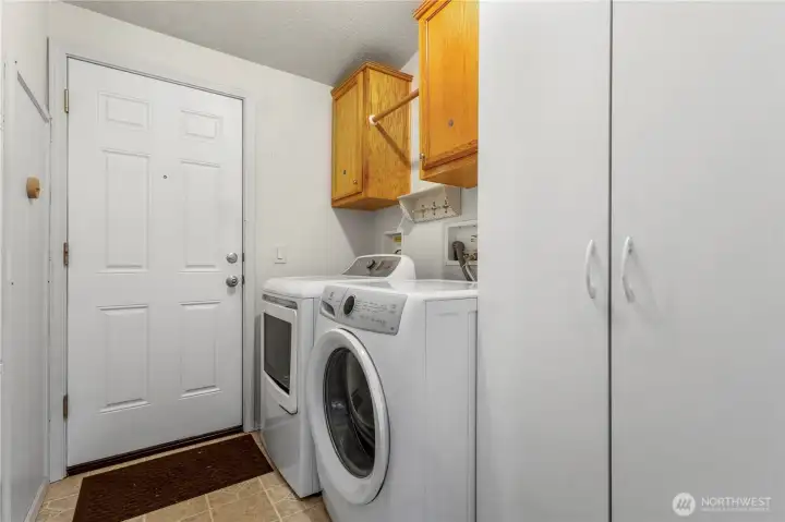 Laundry room includes washer & dryer, storage, and covered carport access to the home.