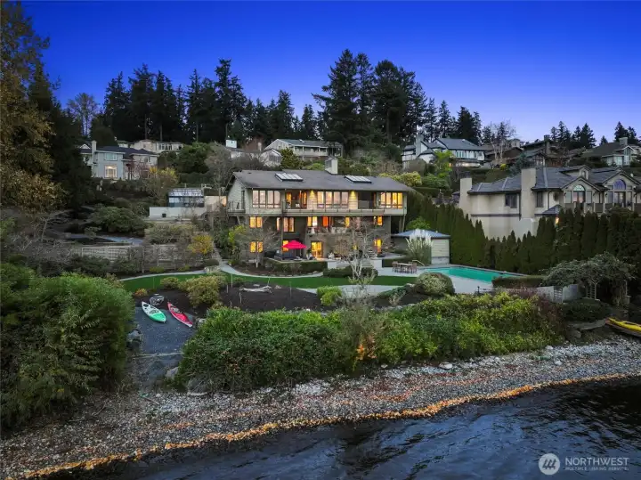 A truly magnificent and rare Lake Washington offering—this iconic southwest-facing waterfront estate spans two parcels at the end of a private gated lane, with an extraordinary 161 feet of no-bank shoreline and sweeping, panoramic views of the lake, Mount Rainier, city skylines, rose-colored sunsets, and endless maritime activity – it is ever-changing art at its finest