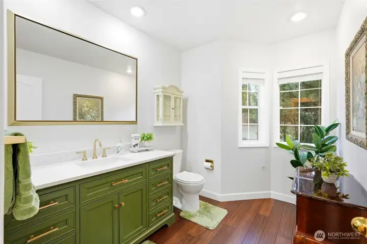 Updated bathroom with dual vanity, modern finishes, and spa-like ambiance in this Lake Wilderness view retreat.