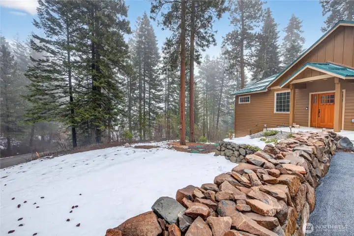 Front yard with rustic stone ledge.