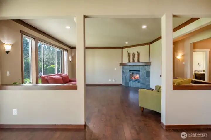 View from breakfast nook into living room with gas fireplace