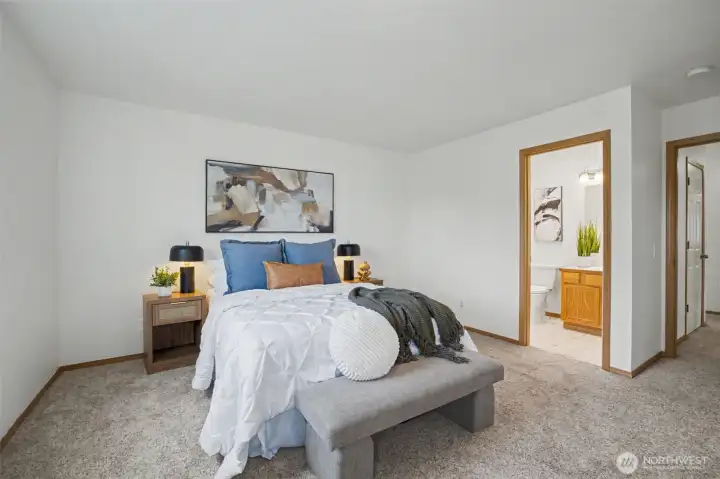 Primary bedroom with neutral tones and natural light.