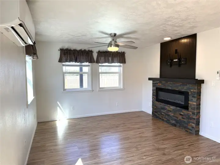 Living room with furniture removed.  Fireplace is a wonderful feature with TV hook ups in place.