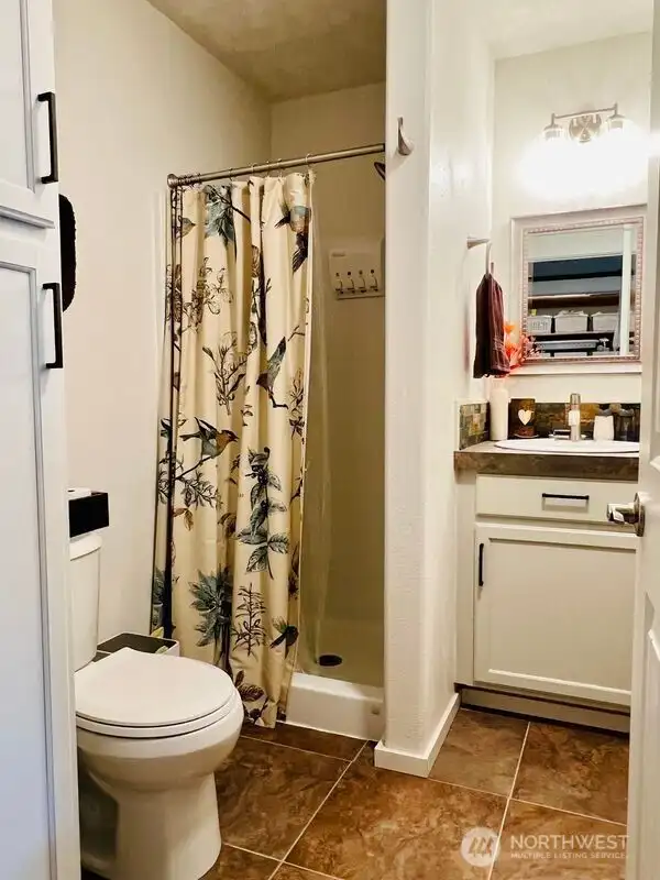 3/4 Bath in hallway. Porcelain Tile floors.