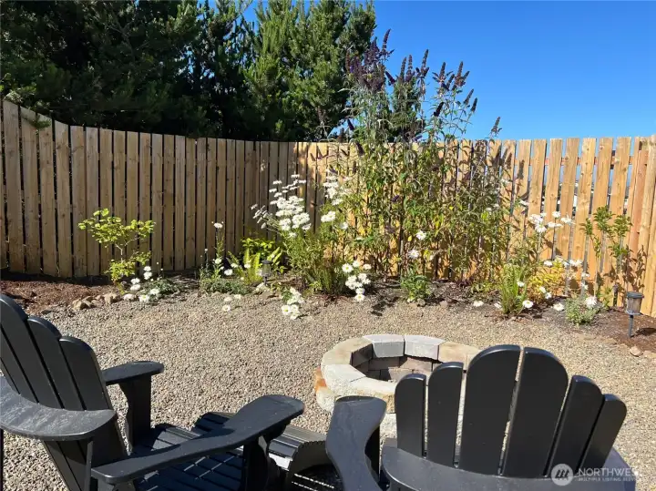 In the front yard completely landscaped and privacy.