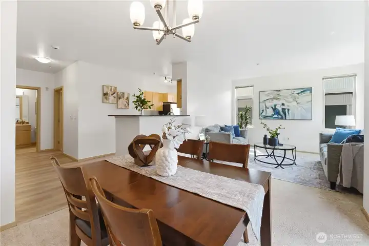 Open sightline from the dining area through the living room and into the kitchen