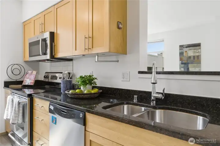 Spacious, light-filled kitchen with granite counters and generous workspace