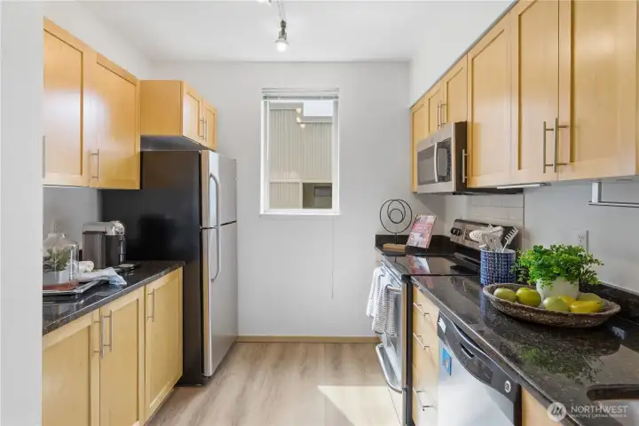 Maple-cabinet kitchen with stainless steel appliances and a clean, modern layout.