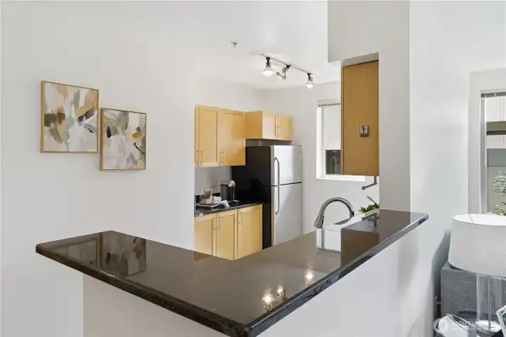 Granite countertop bar offering additional seating and casual dining space