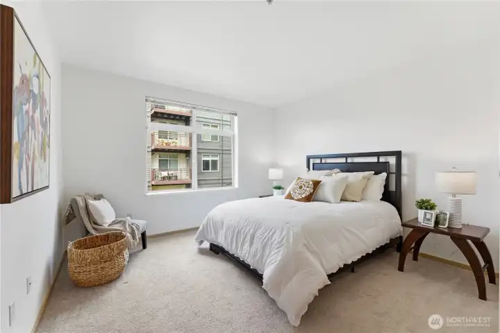 Bright primary bedroom featuring a generous walk-in closet