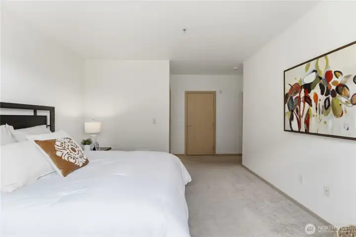 Additional angle of the primary bedroom, with the door to the spacious walk-in closet ahead