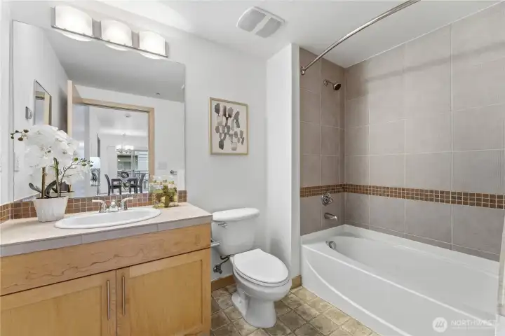Well-appointed guest bathroom with generous counter space and a full tub/shower