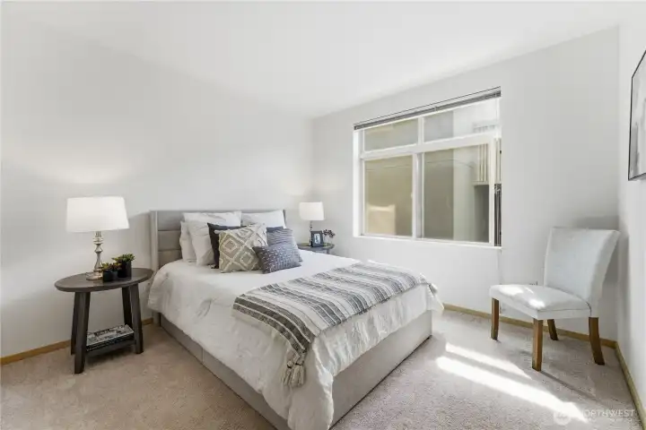 Guest bedroom with ample closet space; all windows come with included blinds