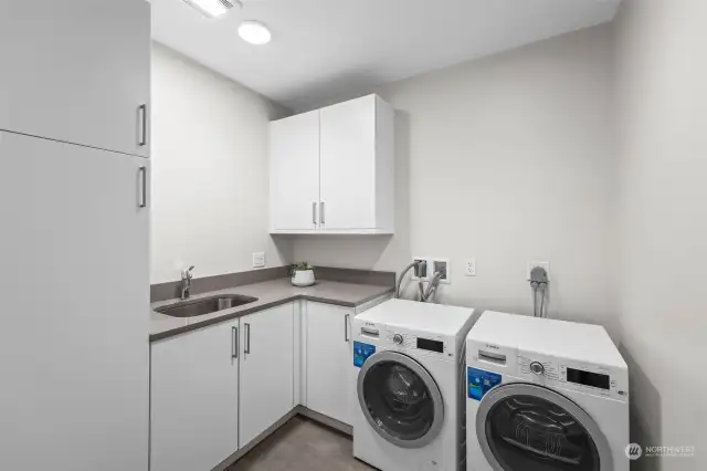 Bosch laundry system, sink, and plenty of storage in your laundry room!