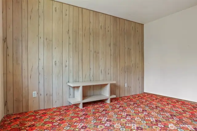 Primary bedroom with original carpet and wood paneling!