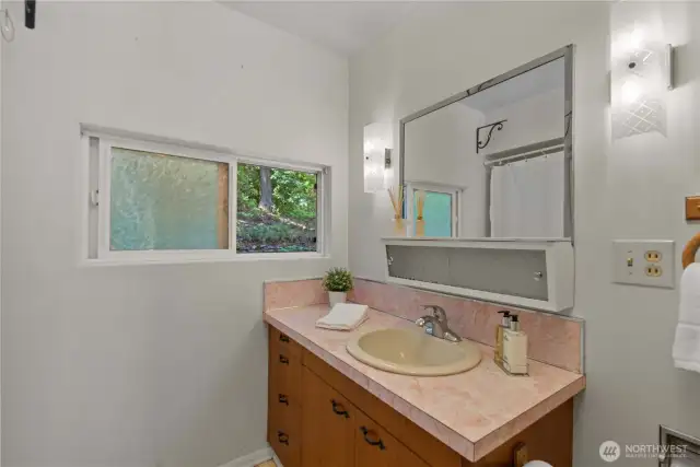 The main floor full bath is located between the two main floor bedrooms.
