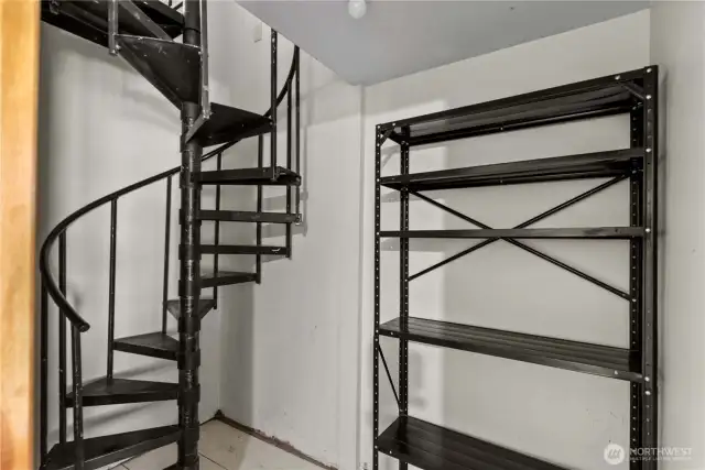Here's a surprise! A secret spiral stairway leading to the kitchen. Made it easy to access all of the homemade preserves, fruits & veggies stored in the cool storage space in this little room (which also has a door to the outside).