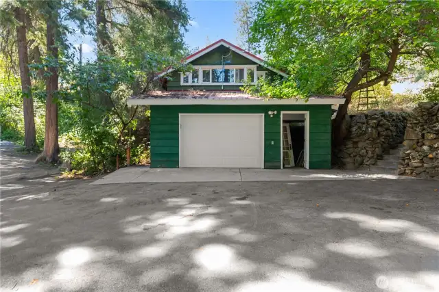 The 1 car garage has a sleeping area on the upper level with a partial kitchen and everything you need in the bathroom except the toilet, since the nearby outhouse served that purpose.