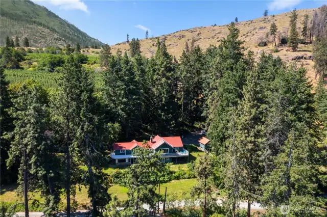 Nicely nestled in the trees with neighboring orchards back behind.