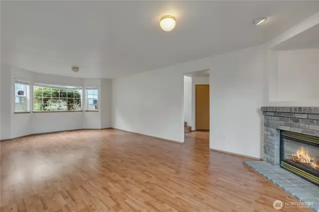 Giant family room downstairs with brick gas fireplace