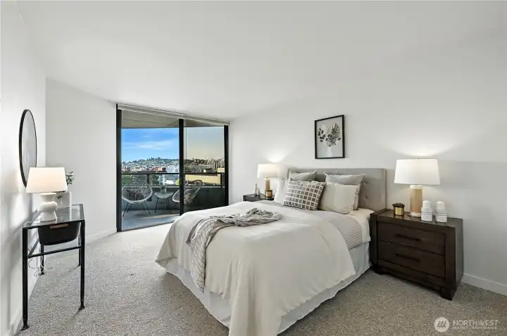 Wonderful king size primary suite leads to breathtaking Space Needle views off the covered deck!